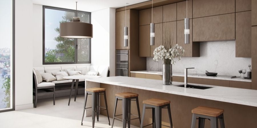 Off-white kitchen featuring brown and black cabinets and chairs.