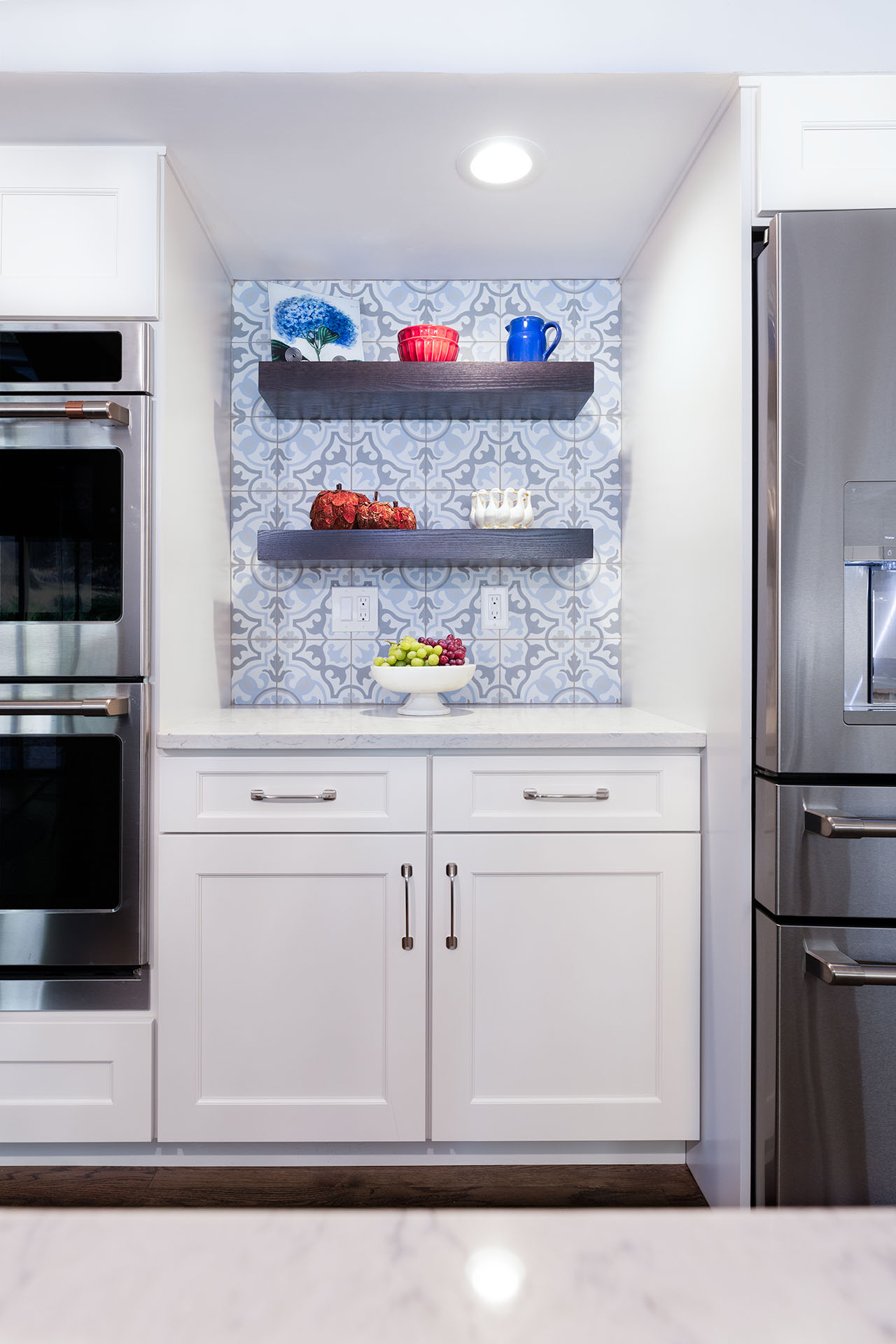 Custom wet bar featuring patterned tile backsplash and open shelving for a functional yet eye-catching design Custom wet bar featuring patterned tile backsplash and open shelving for a functional yet eye-catching design