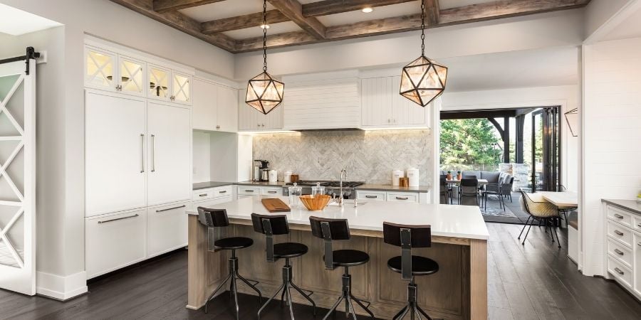 transitional style kitchen with drop pendant lighting and metal and wood accents