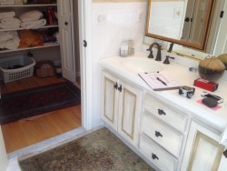 Before photo shows old vanity and linen closet.
