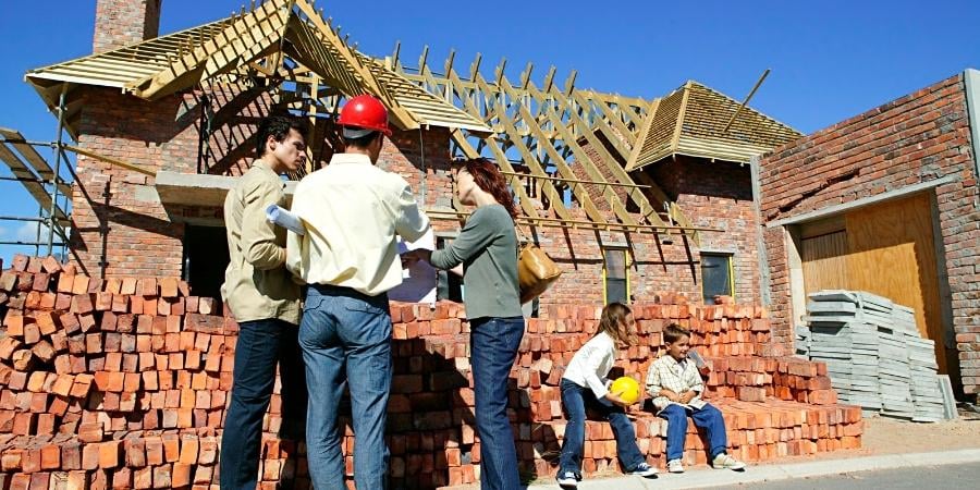 Remodeler Contractors Talking in Front of a House Being Build