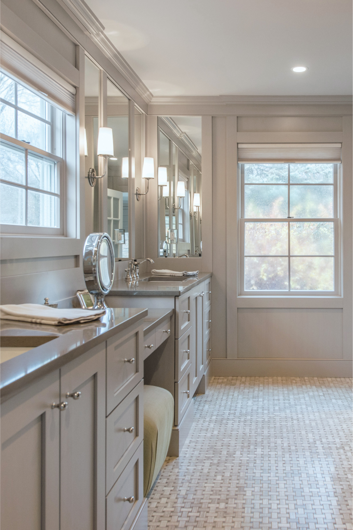 Gray sophisticated bathroom featuring a spacious vanity, elegant finishes, and a large window that fills the room with natural light. Gray sophisticated bathroom featuring a spacious vanity, elegant finishes, and a large window that fills the room with natural light.