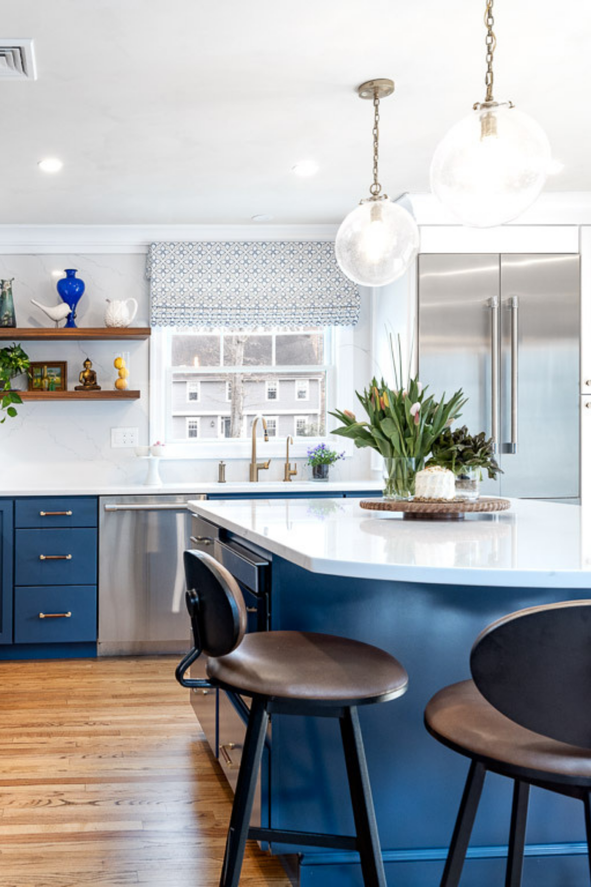 Kitchen with bold blue cabinets and matching island, complemented by warm wood floors and modern finishes for a stylish, cohesive look. Kitchen with bold blue cabinets and matching island, complemented by warm wood floors and modern finishes for a stylish, cohesive look.
