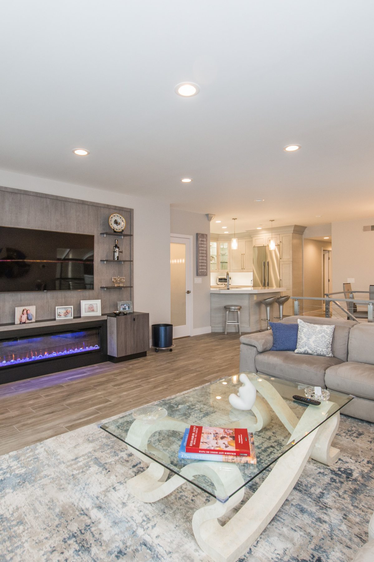 Gray-toned first floor remodel featuring a custom fireplace, open layout, and modern finishes for a cohesive and inviting living space. Gray-toned first floor remodel featuring a custom fireplace, open layout, and modern finishes for a cohesive and inviting living space.