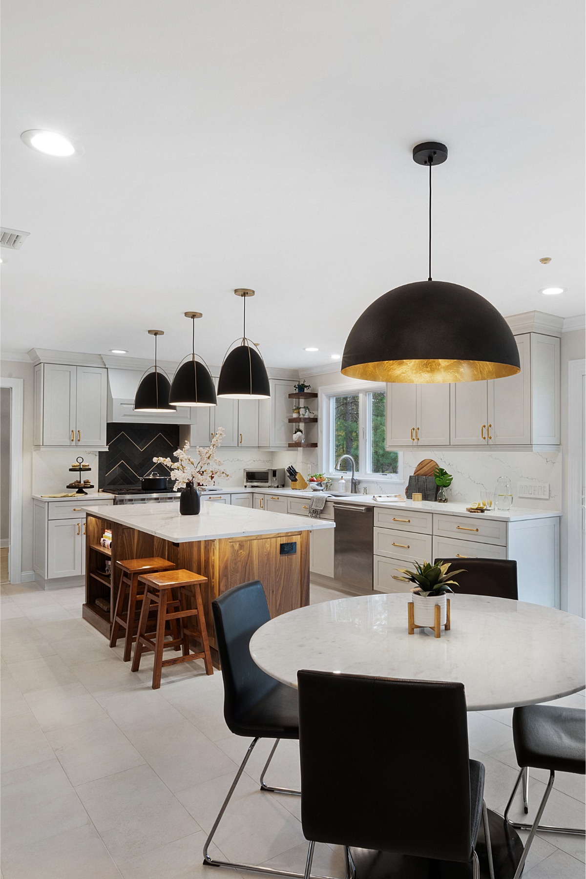Transitional kitchen featuring a warm wood island with built-in bookshelf-style shelves, black fixtures, and a dark-toned backsplash behind the oven for a balanced, modern-meets-classic design. Transitional kitchen featuring a warm wood island with built-in bookshelf-style shelves, black fixtures, and a dark-toned backsplash behind the oven for a balanced, modern-meets-classic design.