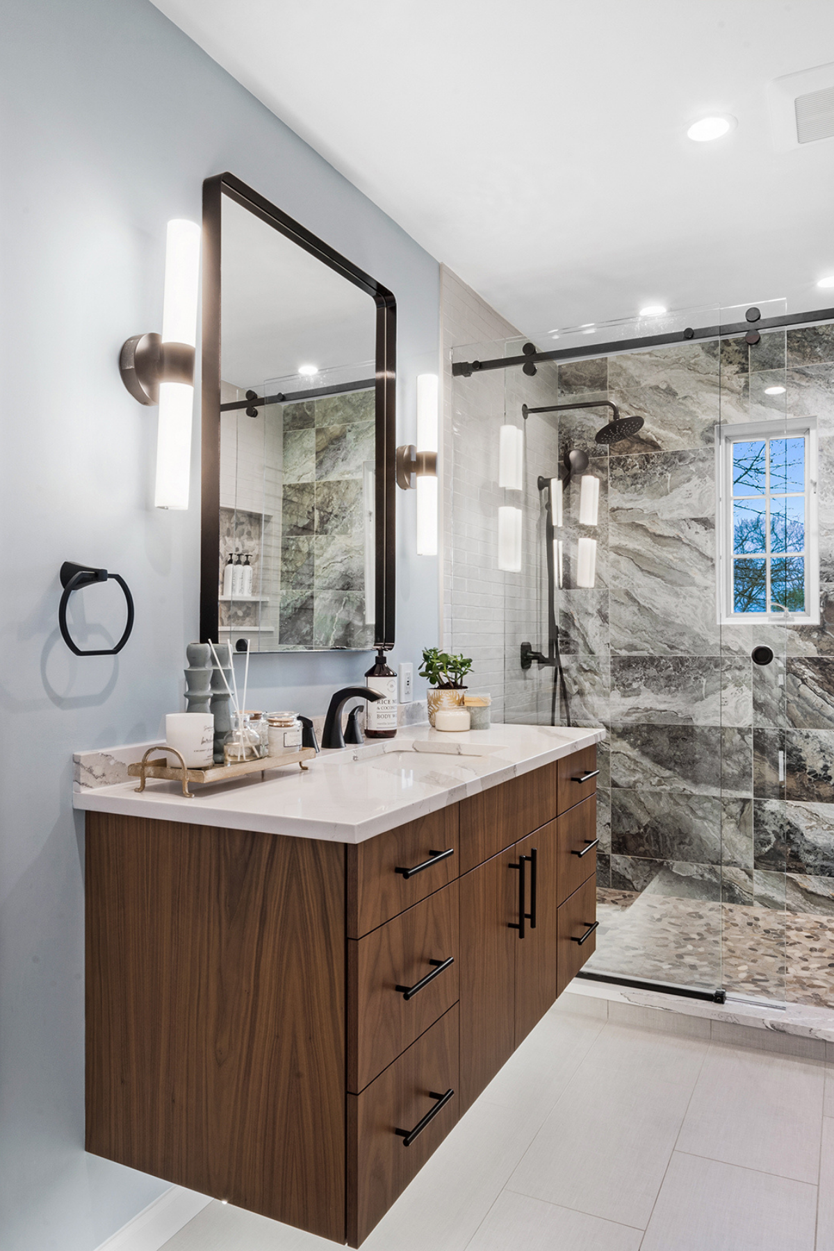 Floating vanity paired with a nature-inspired tile shower and glass enclosure, creating a modern, spa-like bathroom retreat Floating vanity paired with a nature-inspired tile shower and glass enclosure, creating a modern, spa-like bathroom retreat