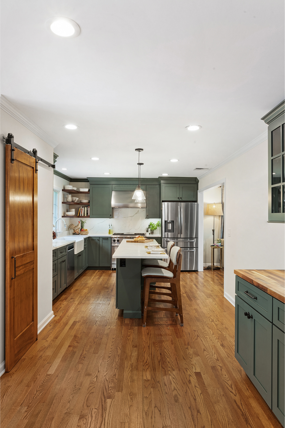 Green kitchen with warm wood accents and crisp white countertops, blending natural tones for a fresh, inviting space Green kitchen with warm wood accents and crisp white countertops, blending natural tones for a fresh, inviting space