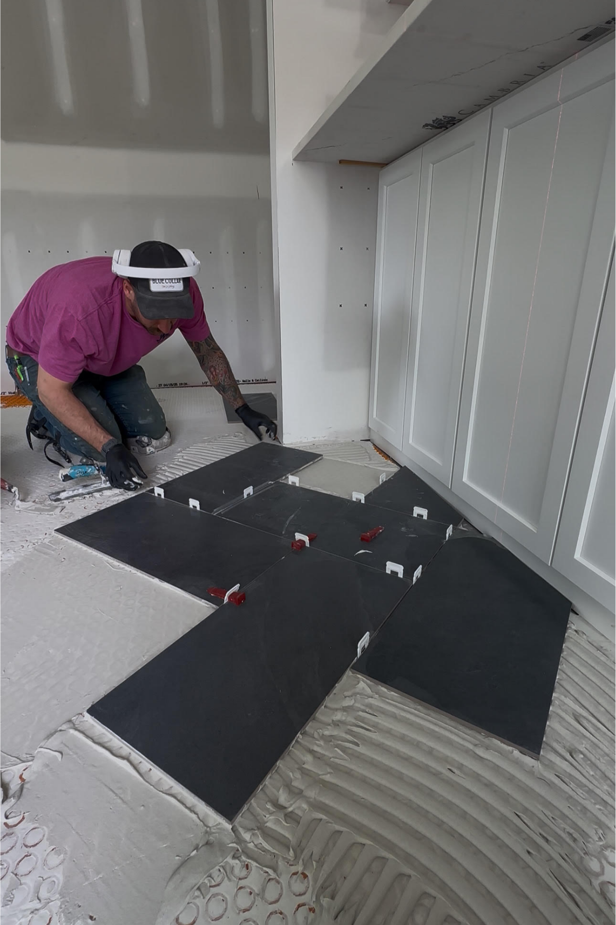 JMC tile expert carefully laying tile and back buttering for a precise, long-lasting installation with professional attention to detail JMC tile expert carefully laying tile and back buttering for a precise, long-lasting installation with professional attention to detail