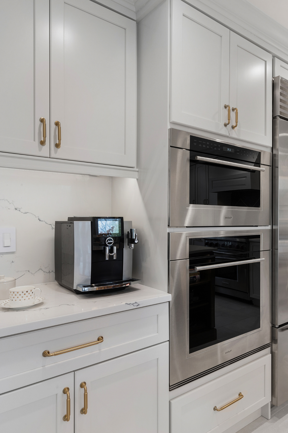 Sleek, modern kitchen appliances including a stainless steel refrigerator, oven, and dishwasher integrated into a contemporary kitchen design.