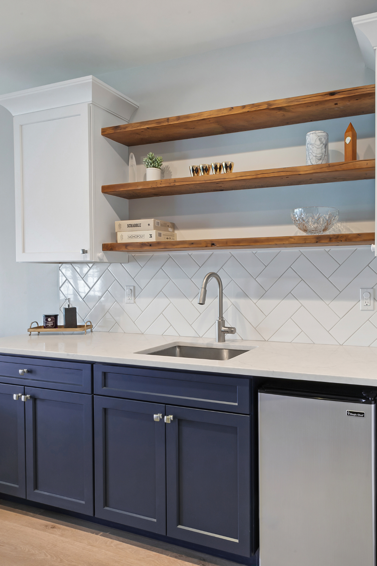 asement wet bar with sink, blue cabinets, and open shelving, combining style and functionality for entertaining. asement wet bar with sink, blue cabinets, and open shelving, combining style and functionality for entertaining.