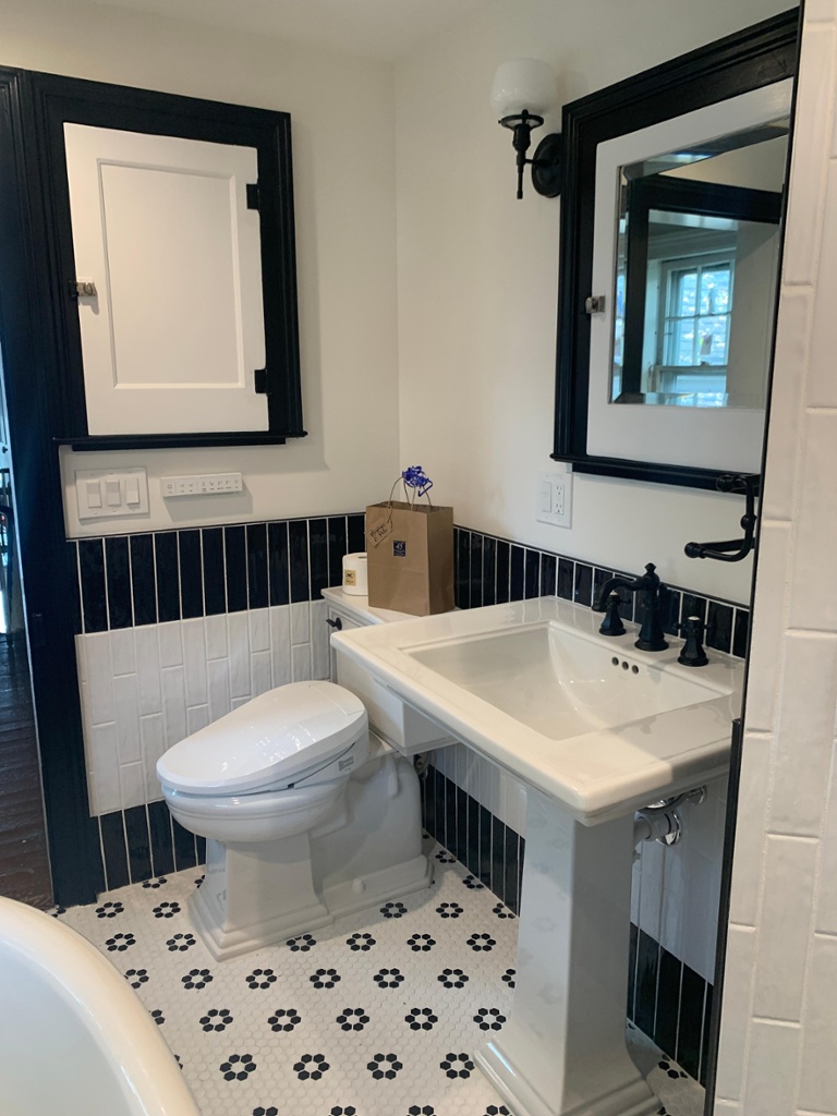 Vintage black & white soaking claw foot tub with pedestal sink in Boonton Renovated by JMC