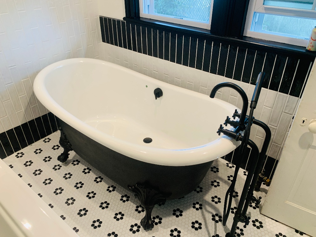 Vintage black & white soaking claw foot tub with pedestal sink in Boonton Renovated by JMC