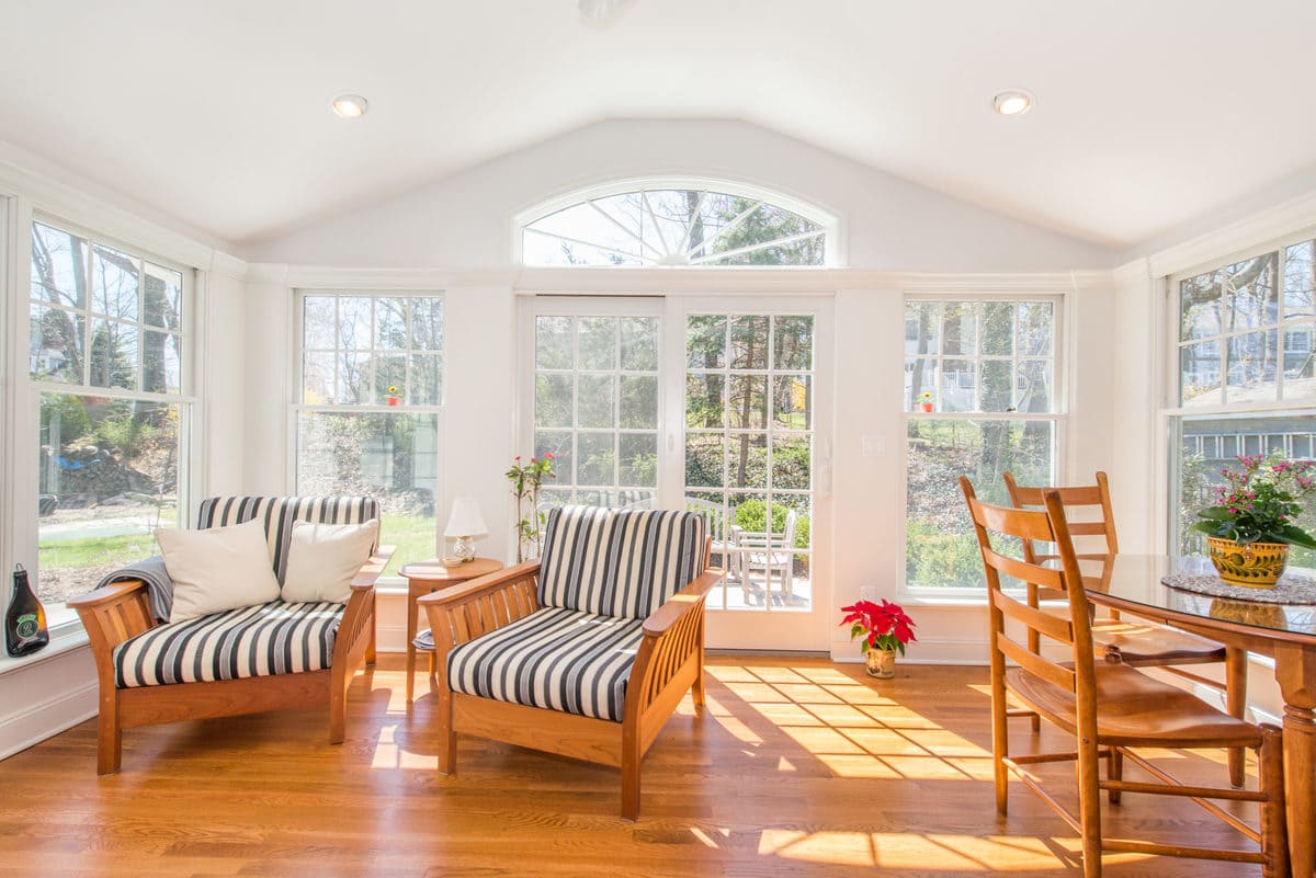 White Sunroom with vaulted ceiling and transom window in Chatham, NJ renovated by JMC Home Improvement Specialists