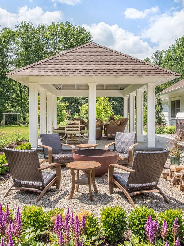 Pavilion with custom traditional paneled columns and open ceiling with fire pit in Boonton, NJ renovated by JMC Home Improvement Specialists