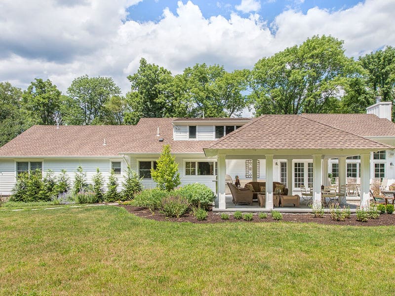 Pavilion with tongue and groove roof decking, white custom traditional paneled columns on blue stone patio with garden in Boonton, New Jersey remodeled by JMC Home Improvement Specialists