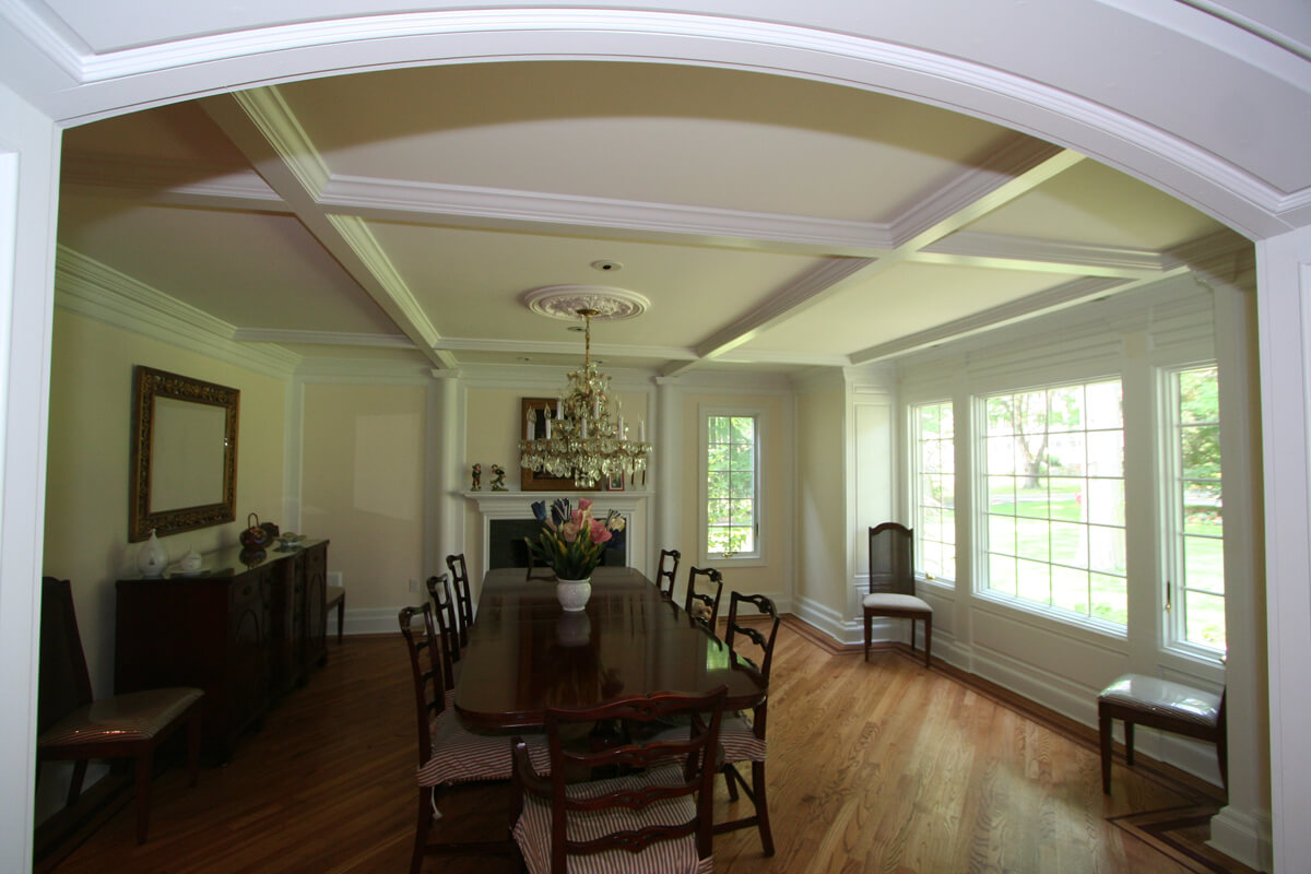 Dining room with custom arch and wall panel and decorative columns with diagonal oak hardwood flooring in Mt Lakes, NJ renovated by JMC Home Improvement Specialists