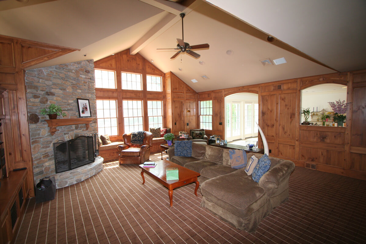 Authentic knotty pine paneling with window seat, ledge stone fireplace and vaulted ceiling with transom windows in Mt Lakes, NJ renovated by JMC Home Improvement Specialists