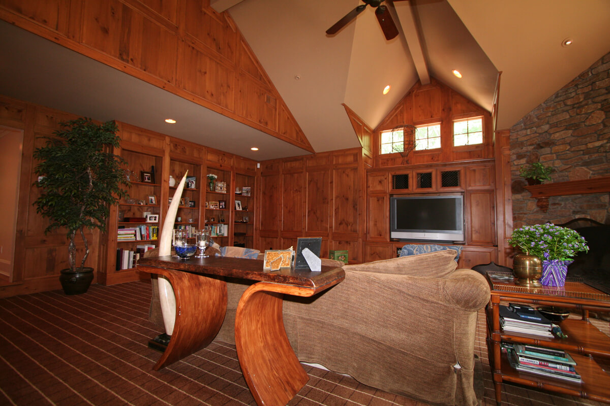 Authentic knotty pine paneling with built in bookcase, ledge stone fireplace and vaulted ceiling with transom windows in Mt Lakes, NJ renovated by JMC Home Improvement Specialists