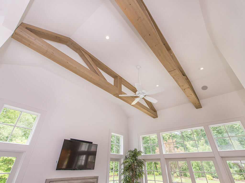 Rustic family room vaulted ceiling with LED highhats, reclaimed wood beams and ceiling fan in Boonton, NJ renovated by JMC Home Improvement Specialists