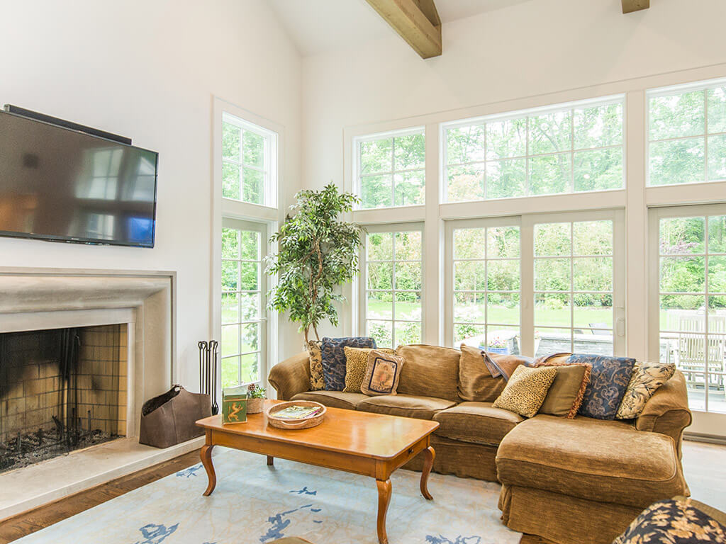 Rustic family room fireplace and window wall with Andersen windows in Boonton, NJ renovated by JMC Home Improvement Specialists