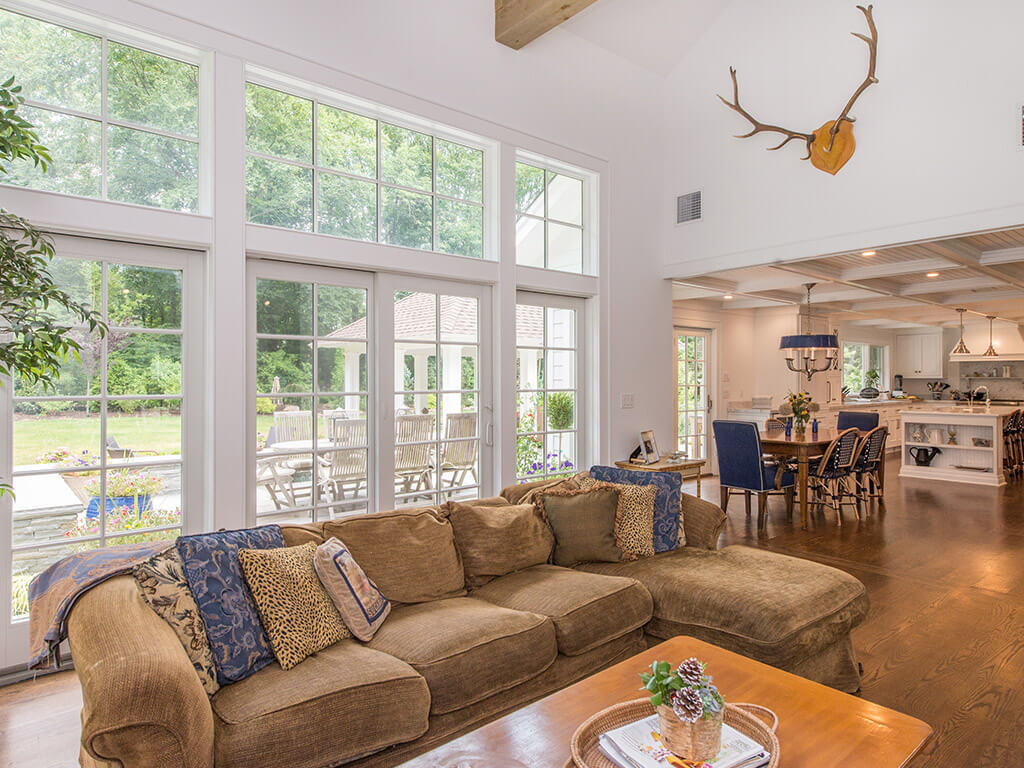 Rustic family room window wall with Andersen windows and doors with cape-cod open concept kitchen in Boonton, NJ renovated by JMC Home Improvement Specialists