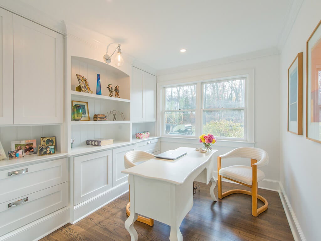 White office with 7” oak floors with white cabinetry, retro lighting with custom shelving with decorative display in Boonton, NJ renovated by JMC Home Improvement Specialists