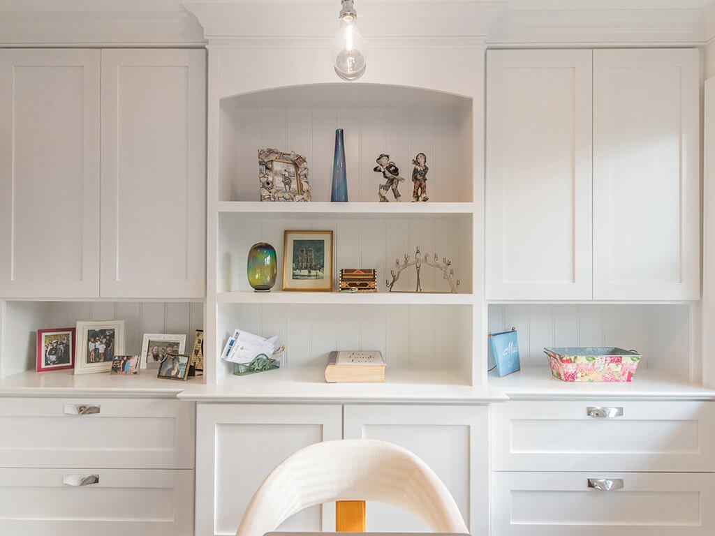 White office with white cabinetry and custom shelving with decorative display in Morris County, NJ renovated by JMC Home Improvement Specialists