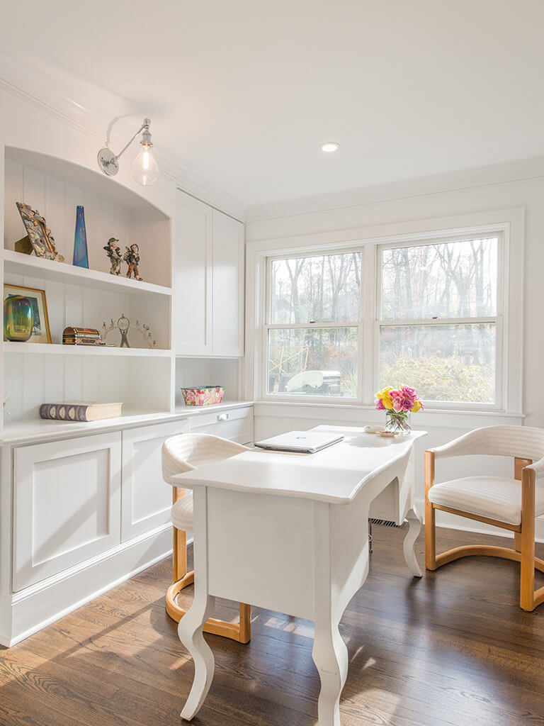 White office with 7” oak floors with white cabinetry, retro lighting with custom shelving with decorative display in Morris County, NJ renovated by JMC Home Improvement Specialists