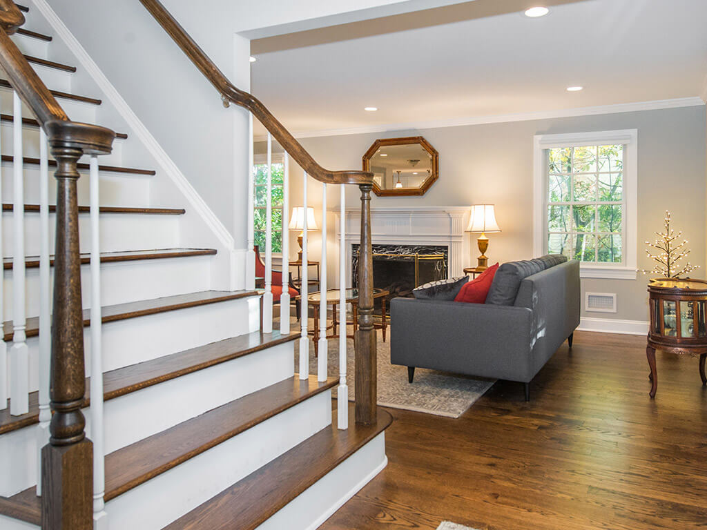 Open railing banister stairwell with hardwood floor in Springfield, New Jersey renovated by JMC Home Improvement Specialists