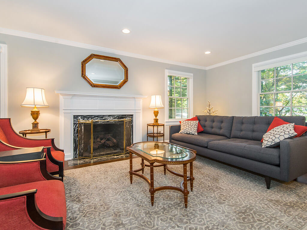 Family room with custom wood paneled fireplace, hardwood floor throughout in Springfield, NJ renovated by JMC Home Improvement Specialists