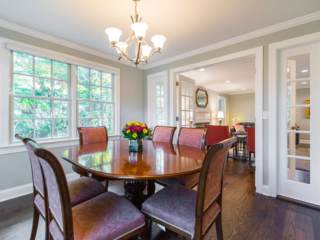 Grey dining room with glass panel French door entrance with side transoms and hardwood floor in Springfield, NJ renovated by JMC Home Improvement Specialists