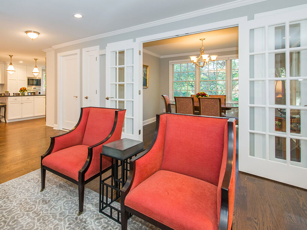 French door dining room entrance with side transoms, hardwood floor with white trim and grey interior walls leading into renovated kitchen in Springfield, NJ remodeled by JMC Home Improvement Specialists