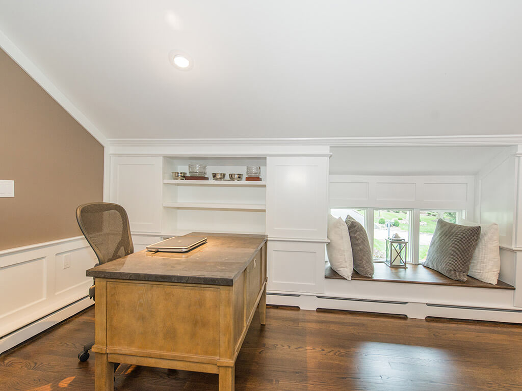 Custom window bench and custom wood heat cover with desk area in family room In Randolph, New Jersey renovated by JMC Home Improvement Specialists