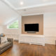 Custom white entertainment area with vaulted ceiling and custom heat covers and hardwood floor in family room In Randolph, New Jersey renovated by JMC Home Improvement Specialists