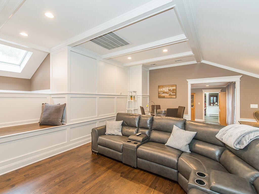 Custom bench and vaulted ceilings with hardwood floor and custom wood working in family room In Randolph, New Jersey renovated by JMC Home Improvement Specialists