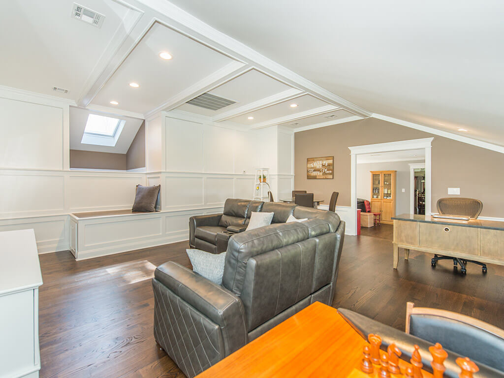 Custom bench and vaulted ceilings with hardwood floor and custom wood working on ceiling with led high hats in family room In Randolph, New Jersey renovated by JMC Home Improvement Specialists