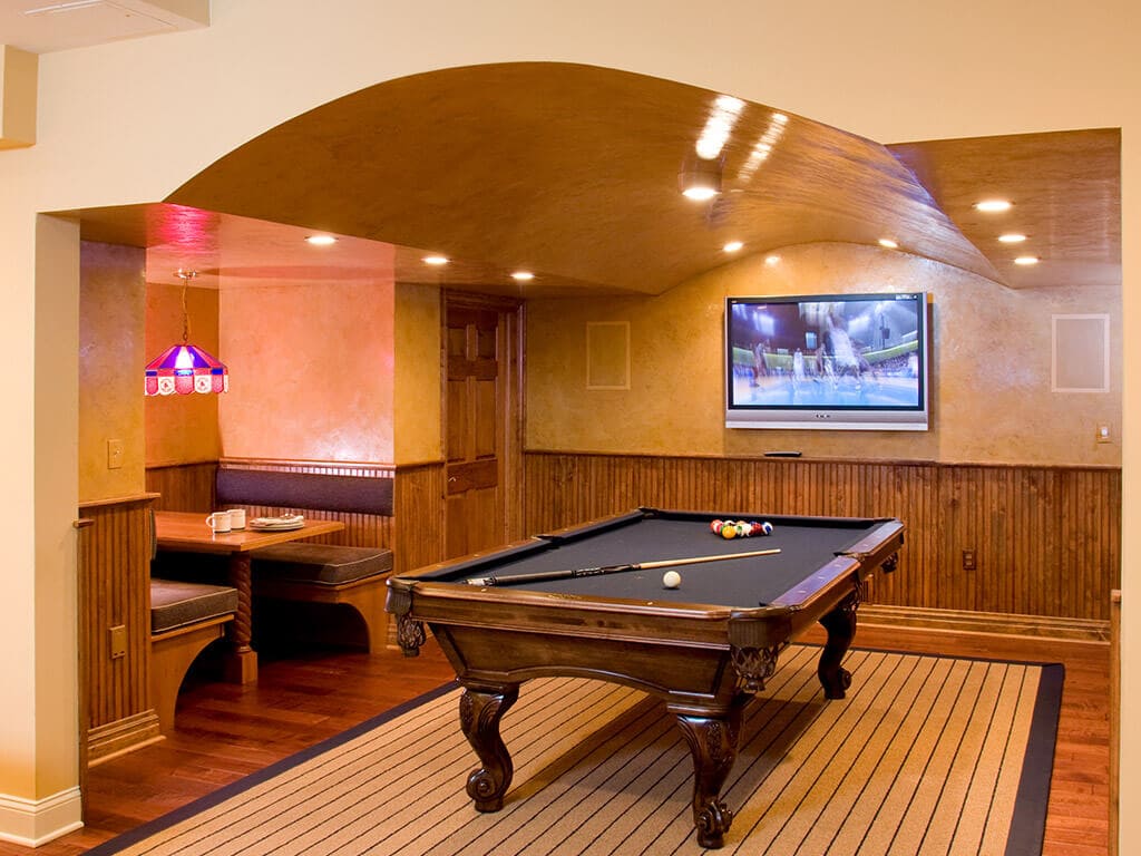 Basement pool room with built in bench seating with curve ceiling with faux finishing in Randolph New Jersey Renovated by JMC Home Improvement Specialists