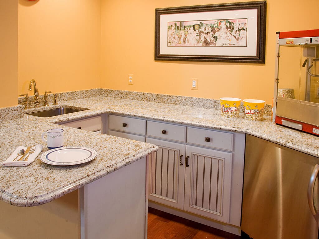 Basement remodel with granite counters wet bar with popcorn machine for watching movies in custom theatre room in Randolph New Jersey Renovated by JMC Home Improvement Specialists