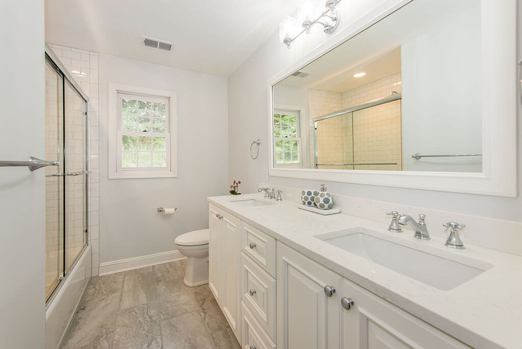 White Hall Bath Remodel in Morris Township New Jersey with Quartz Countertop Vanity Framed Mirror and Wood Floor Tile Renovated by JMC Home Improvement Specialists