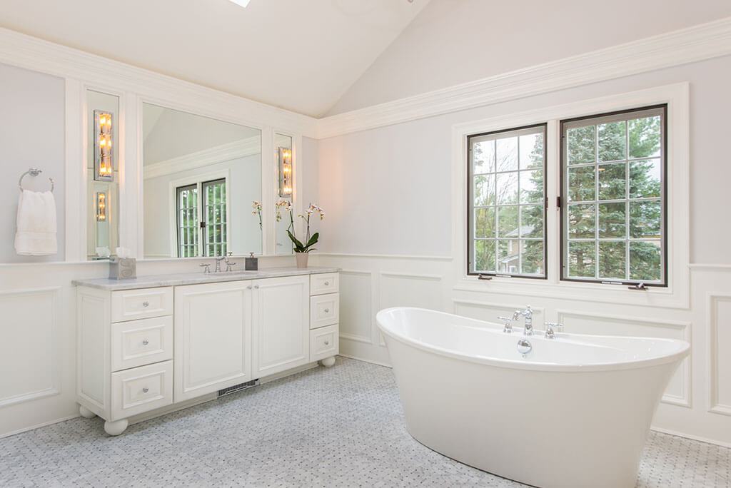 Award Winning Elegant White Master Bathroom Remodel with Custom Wood Panel and Sconces with Soaking Tub in Morris Township New Jersey Renovated by JMC Home Improvement Specialists