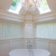 Freestanding soaking tub with custom curtains chandelier bathroom remodel in Sparta NJ renovated by JMC Home Improvement Specialists