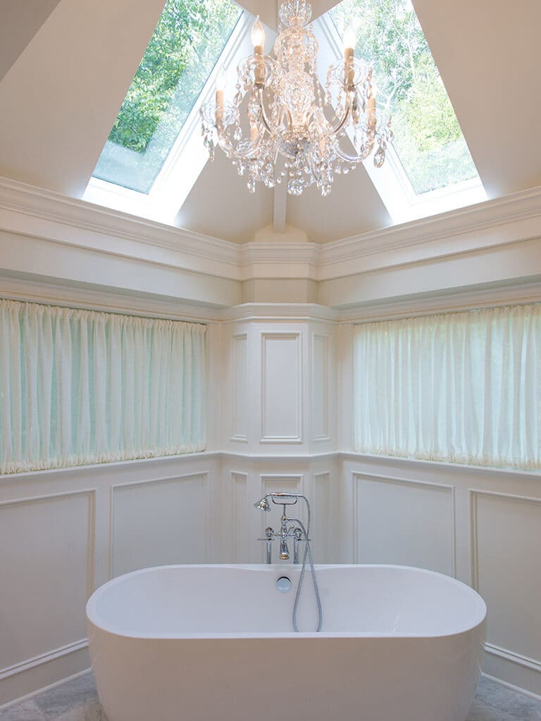 Freestanding soaking tub with custom curtains chandelier bathroom remodel in Sparta NJ renovated by JMC Home Improvement Specialists