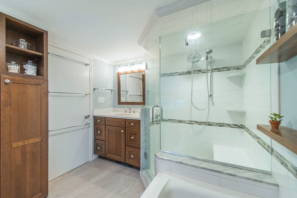 Master bathroom with Linen storage cabinet, Neo angle shower with subway tile with accent stripe in glass and stone mosaic in Bernardsville, NJ renovated by JMC Home Improvement Specialists