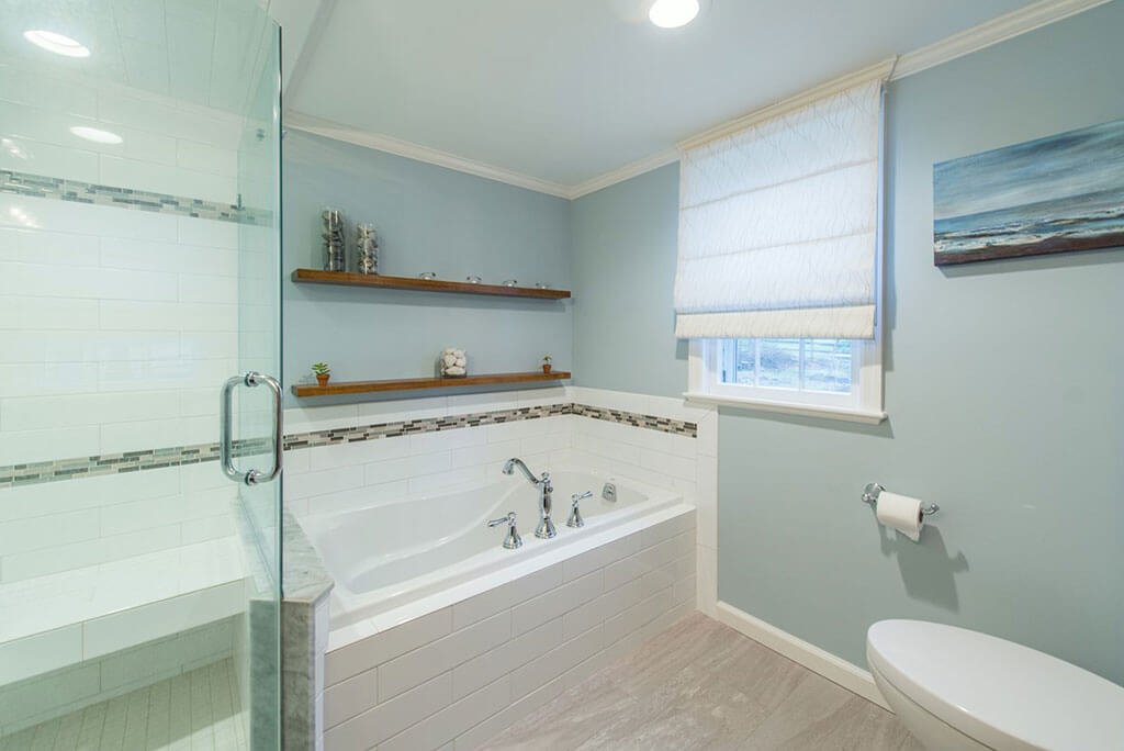 Master bathroom with soaking tub, subway tile with accent stripe in glass and stone mosaic in Bernardsville, NJ renovated by JMC Home Improvement Specialists