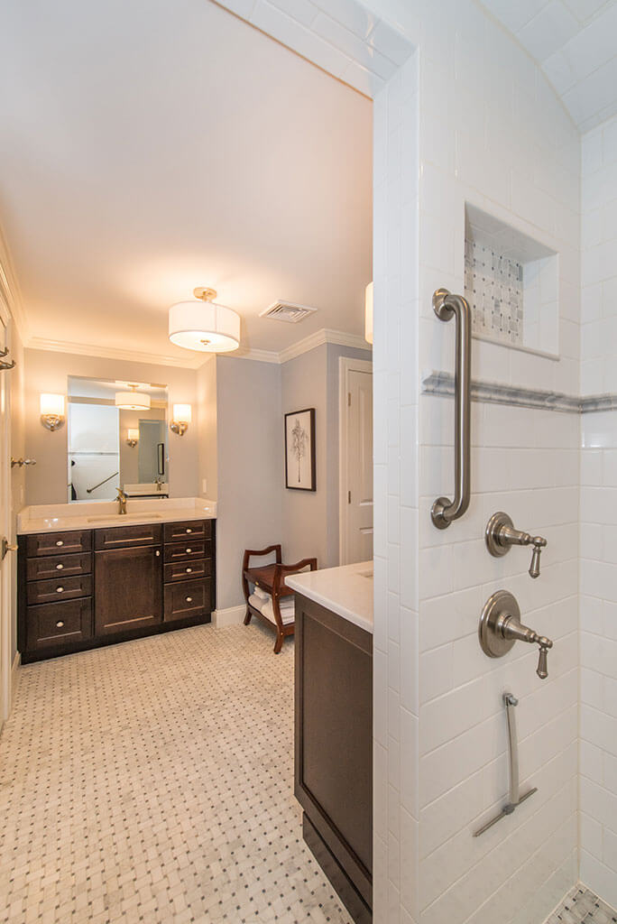 Master bathroom remodel with espresso vanities and basketweave tile floor, shower niche, white subway tile and grab bar Boonton, NJ renovated by JMC Home Improvement Specialists