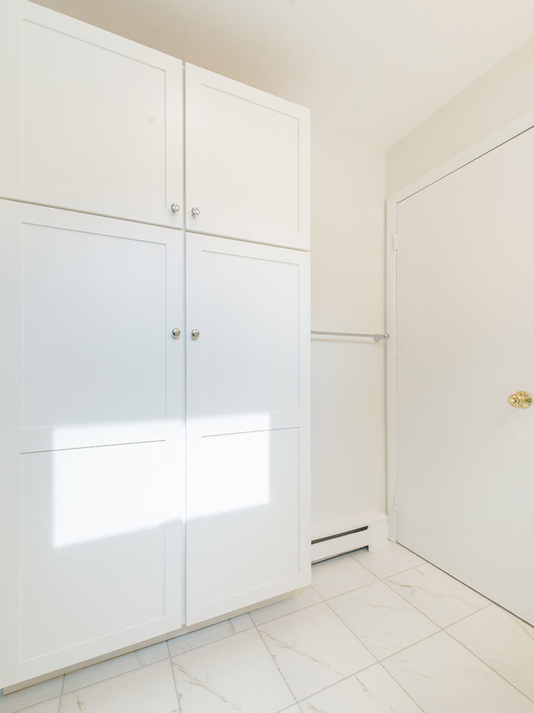 Bright white linen cabinet in bathroom remodel with mosaic tile in Mt Tabor, NJ renovated by JMC Home Improvement Specialists