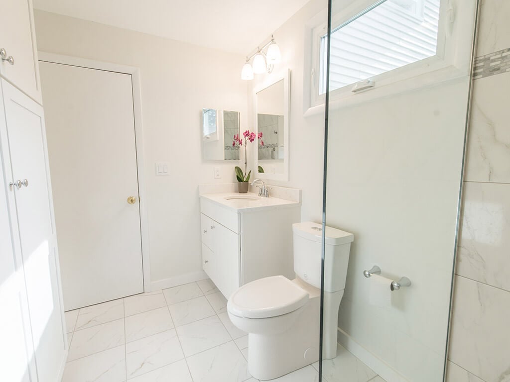 Bright white handicap bathroom remodel with mosaic tile, white vanity with quartz countertop in Mt Tabor, NJ renovated by JMC Home Improvement Specialists