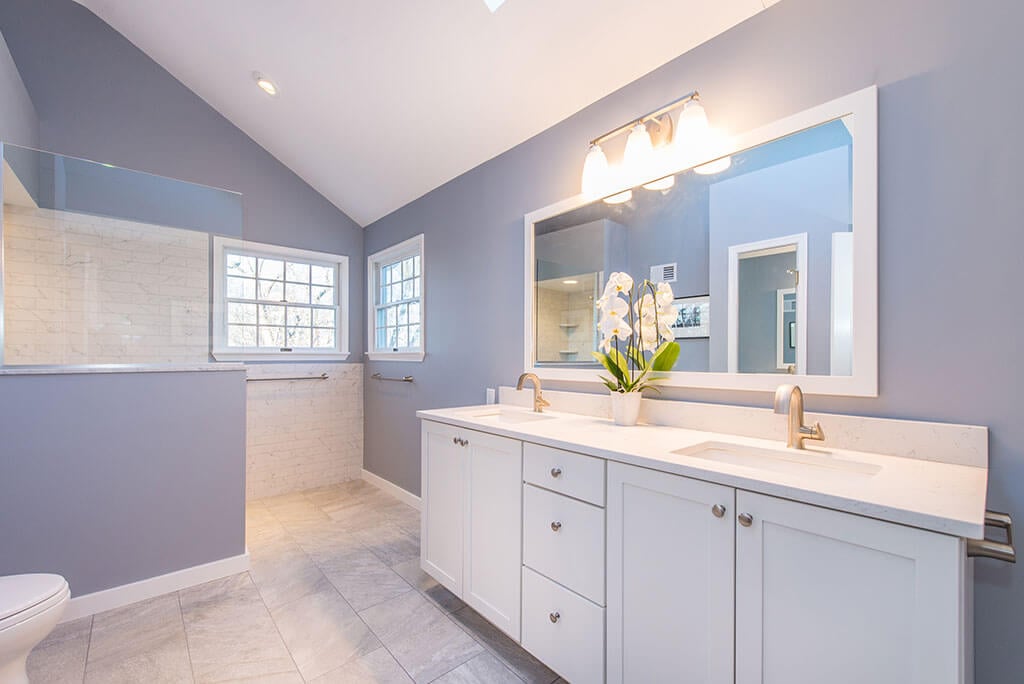 Master bathroom remodel in Chatham, NJ with walk-in shower and dual white shaker vanity and framed mirror renovated by JMC Home Improvement Specialists