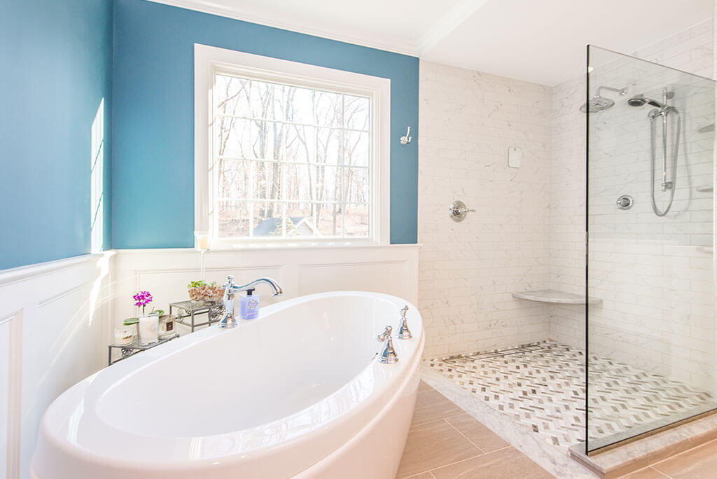Master bathroom remodel soaking tub, wall paneling, walk in shower with clear glass shower panel, wood like tile floor in Chester, NJ renovated by JMC Home Improvement Specialists