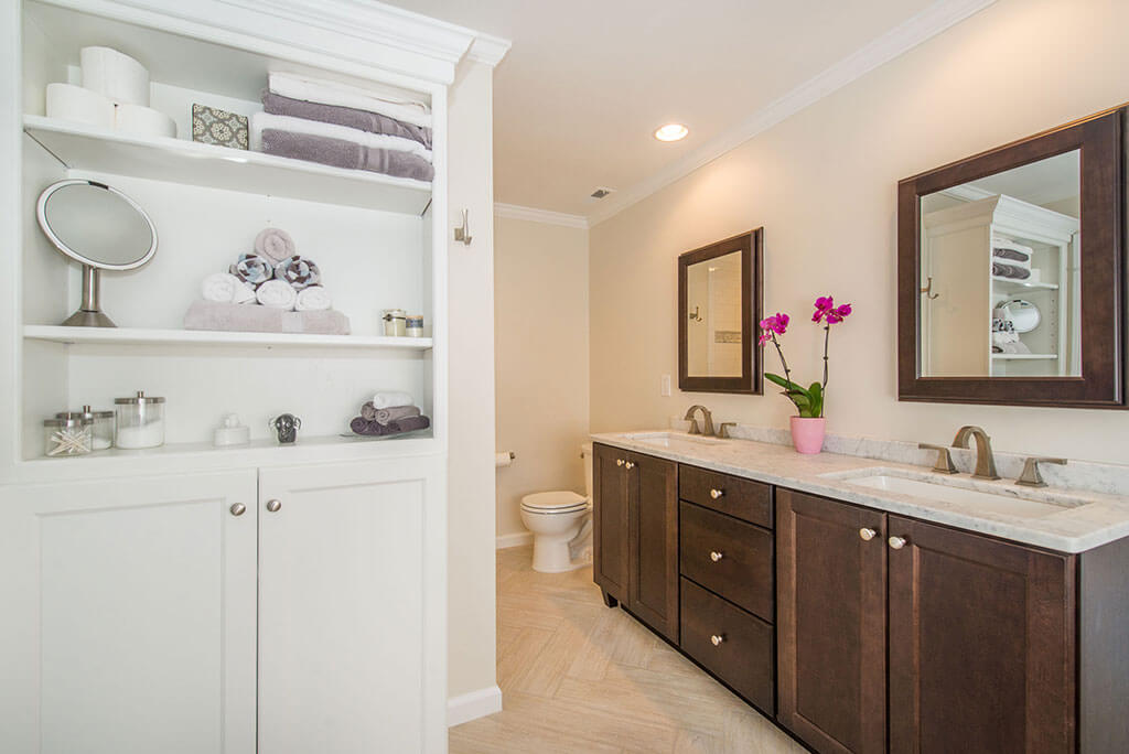 Master bathroom remodel with dark wood vanity, rectangular undermount sinks with granite counters, wood framed mirrors, white open shelving in linen cabinet in Lake Hopatcong, NJ renovated by JMC Home Improvement Specialists